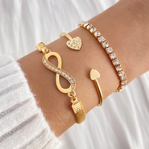 A Set of Three Women'S Bracelets And Bangles Featuring Wireless Symbols And Heart Designs Adorned with Rhinestones.